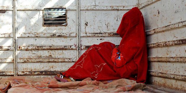 7-year-old child bride Guddu Bai sits at the back of a truck as she waits for the rest of her family members after being wed, at Biaora, about 135 kilometers from Bhopal, India, Saturday, May 7, 2011. Ignoring laws that ban child marriages, young children are still married off as part of centuries-old custom in some Indian villages. India law prohibits marriage for women younger than 18 and men under age 21. (AP Photo/Prakash Hatvalne)