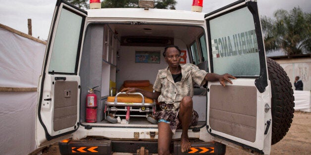 FILE - In this Wednesday, Sept. 24, 2014, file photo, a woman suspected of suffering from Ebola virus sits in an ambulance in Kenema, Sierra Leone. The deadly Ebola virus has infected two people in what was the last untouched district in Sierra Leone, the government said Thursday, Oct. 16, 2014 a setback in efforts to stop the spread of the disease in one of the hardest-hit countries. The Emergency Operations Center in its report covering Wednesday announced the two Ebola cases in the Koinadugu district, in Sierra Leone's far north, which had taken aggressive measures to keep the virus out of its mountainous territory since the outbreak early this year. (AP Photo/ Tanya Bindra, File)