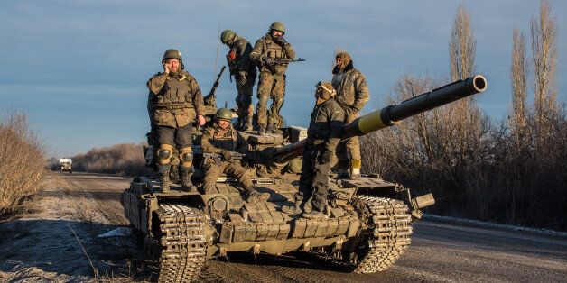 ARTEMIVSK, UKRAINE - FEBRUARY 19: Ukrainian soldiers who left Debaltseve yesterday prepare to return to support the further withdrawal of troops on February 19, 2015 in Artemivsk, Ukraine. Ukrainian forces started withdrawing from the strategic and hard-fought town of Debaltseve yesterday after effectively being surrounded by pro-Russian rebels. (Photo by Brendan Hoffman/Getty Images)