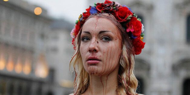 Inna Shevchenko, a member of the Ukrainian feminist protest group FEMEN, stages a protest in front of the Duomo gothic cathedral in Milan, Italy, Thursday, Oct. 16, 2014. The 10th Asia-Europe Meeting (ASEM) will take place in Milan, Italy on Thursday 16 and Friday 17 October, 2014, under the theme "Responsible Partnership for Sustainable Growth and Security". (AP Photo/Luca Bruno)