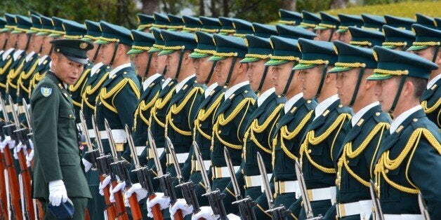 Japan's Self-Defense Force honor guards prepare for a welcoming ceremony of new Defence Minister Gen Nakatani in Tokyo on December 25, 2014. Prime Minister Shinzo Abe promised December 24 at the start of his new term to revive Japan's economy so he can pursue 'powerful diplomacy', but China's state media warned him to be wary about changing the pacifist constitution. AFP PHOTO / KAZUHIRO NOGI (Photo credit should read KAZUHIRO NOGI/AFP/Getty Images)