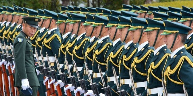 Japan's Self-Defense Force honor guards prepare for a welcoming ceremony of new Defence Minister Gen Nakatani in Tokyo on December 25, 2014. Prime Minister Shinzo Abe promised December 24 at the start of his new term to revive Japan's economy so he can pursue 'powerful diplomacy', but China's state media warned him to be wary about changing the pacifist constitution. AFP PHOTO / KAZUHIRO NOGI (Photo credit should read KAZUHIRO NOGI/AFP/Getty Images)