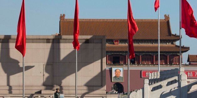 A Chinese paramilitary policeman stands on duty on Tiananmen Square near the Great Hall of the People where delegates are attending sessions of the National People's Congress and Chinese People's Political Consultative Conference in Beijing Tuesday, March 4, 2014. (AP Photo/Ng Han Guan)