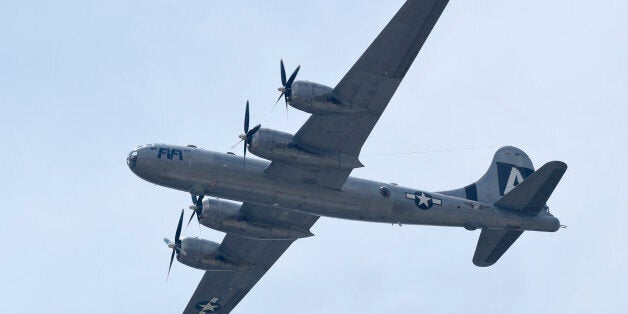 The B-29 Superfortress named "Fifi" and the plane that dropped the atomic bomb, flies over the skies of Washington, Friday, May 8, 2015. Dozens of vintage military aircraft from World War II made the flight over the nation's capital to mark the 70th anniversary of Victory in Europe Day. (AP Photo/Susan Walsh)