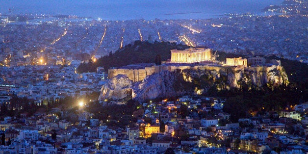 Looking out over Athens at dusk. The Aegean Sea in the background, the birthplace of modern civilization nestles in a valley of low hills with a couple of startling rocky outcrops on the valley floor. Here democracy was born, modern philosophies and formal education came to be and the mighty Persian empire was thwarted. From this valley the Western World grew.