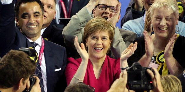 First Minister of Scotland and Scottish National Party leader Nicola Sturgeon, center, celebrates with the results for her party at the count of Glasgow constituencies for the general election in Glasgow, Scotland, Friday, May 8, 2015. The Conservative Party fared much better than expected in Britain's parliamentary election, with an exit poll and early returns suggesting that Prime Minister David Cameron would remain in his office at 10 Downing Street. The opposition Labour Party led by Ed Miliband took a beating, according to the exit poll, much of it due to the rise of the separatist Scottish National Party. (AP Photo/Scott Heppell)