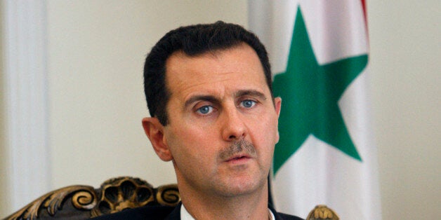 FILE - This Wednesday, Aug. 19, 2009 file photo shows Syrian President Bashar Assad during a meeting with his Iranian counterpart Mahmoud Ahmadinejad in Tehran, Iran. The 48-year-old Assad has led Syria since 2000, taking over as president after the death of his father, Hafez, who ruled the country for some 30 years. Syrians are voting Tuesday in their countryâs first multicandidate presidential election. Previous votes were referendums in which Bashar Assad, and before him his father, Hafez, were the only names on the ballot and Syrians voted yes or no. Despite the presence of challengers on this yearâs ballots, thereâs little doubt that Assad will secure a third seven-year term. (AP Photo/Vahid Salemi, File)
