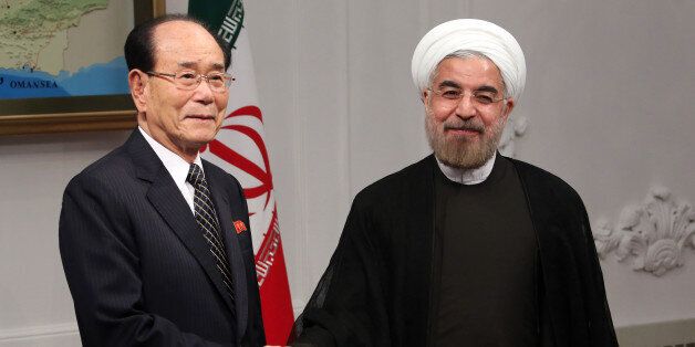 Iran's new President Hassan Rowhani (R) shakes hands with North Korea's ceremonial head of state, Kim Yong-Nam, on his first official day in office in Tehran on August 3, 2013. Moderate cleric Hassan Rowhani assumed Iran's presidency promising to work to lift punishing international sanctions imposed on the Islamic republic over its controversial nuclear programme. AFP PHOTO/ATTA KENARE (Photo credit should read ATTA KENARE/AFP/Getty Images)