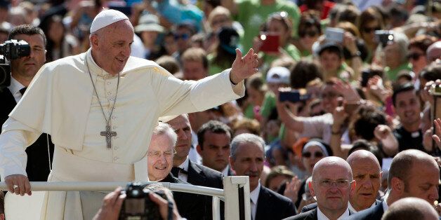Pope Francis waves as his arrives for his weekly general audience, in St. Peter's Square at the Vatican, Wednesday, June 17, 2015. (AP Photo/Andrew Medichini)