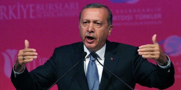 Turkey's President Recep Tayyip Erdogan speaks during a graduation ceremony for foreign students in Ankara, Turkey, Thursday, June 11, 2015. In his first televised appearance since his ruling party lost its parliamentary majority, Erdogan has asked all Turkish political parties to put aside their differences and rapidly form a new government. Erdogan had campaigned voraciously in a bid to win a supermajority for the ruling party, which would have enabled it to change the constitution and usher in a presidential system allowing him to control government affairs. The party is now forced to seek a coalition partnership.(AP Photo/Burhan Ozbilici)