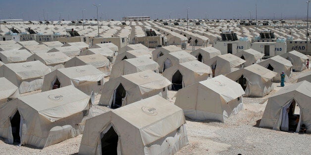 Syrian refugees wander around a refugee camp in Suruc, on the Turkey-Syria border, Friday, June 19, 2015. Ahead of World Refugee Day on Saturday, June 20, 2015, the UN refugee agency, UNHCR, estimated that a total of 11.6 million people from Syria had been displaced by the conflict by the end of last year, the largest such figure worldwide. Turkey is the world's biggest refugee host with 1.59 million refugees, according to the most recent U.N. figures. (AP Photo/Emrah Gurel)