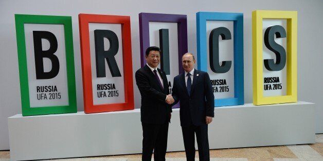 UFA, RUSSIA - JULY 09: In this handout image supplied by Host Photo Agency/RIA Novosti, President of the Russian Federation Vladimir Putin (R) and President of the People's Republic of China Xi Jinping attend the welcome ceremony for the BRICS leaders during the BRICS/SCO Summits - Russia 2015 on July 9, 2015 in Ufa, Russia. (Photo by Host Photo Agency/Ria Novosti via Getty Images)