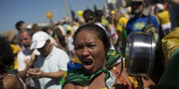 FILE - In this Aug. 16, 2015, file photo, a woman shouts slogans as bangs on a pan during an anti-government protest demanding the impeachment of Brazil's President Dilma Rousseff in Rio de Janeiro, Brazil. Dep. With an economy in recession, along with growing inflation and unemployment, Rousseff has the worst approval rating for any president since Brazil's return to democracy in 1985. (AP Photo/Leo Correa)