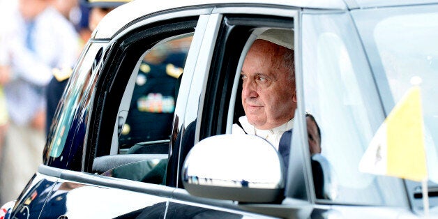 Pope Francis sits in a car after arriving at Joint Base Andrews, Maryland, U.S., on Sept. 22, 2015. Pope Francis's arrival in the U.S. directly from Cuba today is a purposeful bit of symbolism that affirms President Barack Obama's decision to end the half-century of U.S. estrangement from the island nation. Photographer: Olivier Douliery/Pool via Bloomberg