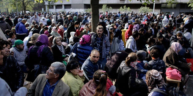 Hundreds of migrants and refugees wait for their registration at Berlin's central registration center for refugees and asylum