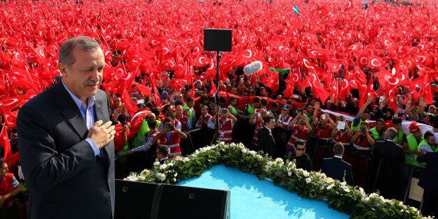 Turkey's President Recep Tayyip Erdogan salutes supporters as tens of thousands of flag-waving demonstrators rally to denounce violence by Kurdish rebels, in Istanbul, Turkey, Sunday, Sept. 20, 2015. Speakers condemned terrorism and the violence which has rocked eastern Turkey since the resumption of fighting between the military and the Kurdistan Workers' Party, or PKK. The separatist group is considered a terror organization by the Turkey, the U.S. and the EU.(Presidential Press Service/Pool photo via AP)