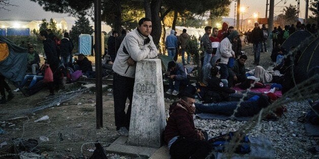 Migrants block railway tracks near Gevgelija, on the Greece-Macedonia border, on November 19, 2015. Countries along the migrant route through the Balkans have begun tightening restrictions on the wave of people crossing their borders by allowing entry only to those fleeing war, aid workers and officials said on November 19. AFP PHOTO / DIMITAR DILKOFF (Photo credit should read DIMITAR DILKOFF/AFP/Getty Images)