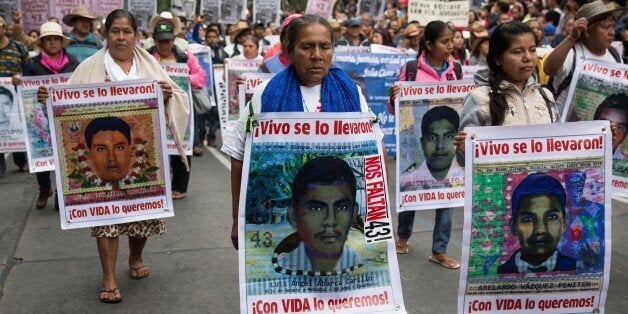 MEXICO CITY, MEXICO - SEPTEMBER 26: Relatives of the 43 missing students take part in a demonstration to mark the one year anniversary of the disappearances of 43 students from the Ayotzinapa Rural Teachers' College, in Mexico City, Mexico, on September 26, 2015 (Photo by Daniel Cardenas/Anadolu Agency/Getty Images)