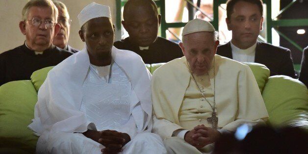 Pope Francis (C) looks on, alongside Imam Nehedid Tidjani (2-L), during a visit to the Central Mosque in Bangui on November 30, 2015. Pope Francis said on November 30 that Christians and Muslims were 'brothers', urging them to reject hatred and violence while visiting a mosque in the Central African Republic's capital which has been ravaged by sectarian conflict. AFP PHOTO / GIUSEPPE CACACE / AFP / GIUSEPPE CACACE (Photo credit should read GIUSEPPE CACACE/AFP/Getty Images)