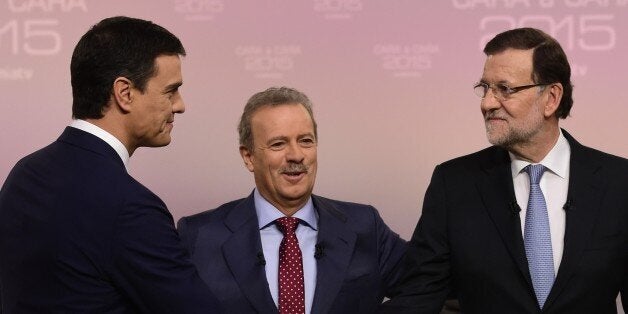 Spanish Prime Minister and Popular Party (PP) leader and candidate in the December 20 general elections, Mariano Rajoy (R) shakes hands with Spanish Socialist Party (PSOE) leader and candidate in the December 20 general elections, Pedro Sanchez (L) as they pose with Spanish journalist Manuel Campo Vidal before a face to face TV debate at Pozuelo de Alarcon, near Madrid on December 14, 2015. AFP PHOTO/ JAVIER SORIANO / AFP / JAVIER SORIANO (Photo credit should read JAVIER SORIANO/AFP/Getty Images)