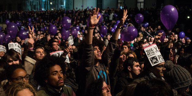 BARCELONA, SPAIN - DECEMBER 21: Podemos (We Can) supporters reacts as their leader Pablo Iglesias delivers a speach on Spain General Elections' results on December 21, 2015 in Madrid, Spain. Spaniards went to the polls today to vote for 350 members of the parliament and 208 senators. For the first time since 1982, the two traditional Spanish political parties, right-wing Partido Popular (People's Party) and centre-left wing Partido Socialista Obrero Espanol PSOE (Spanish Socialist Workers' Party), held a tight election race with two new contenders, Ciudadanos (Citizens) and Podemos (We Can) attracting right-leaning and left-leaning voters respectively. (Photo by David Ramos/Getty Images)