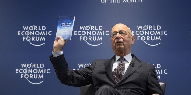 World Economic Forum (WEF) founder and executive chairman Klaus Schwab shows a book he wrote during a news conference on the programme of the Davos World Economic Forum WEF annual meeting at the Forum's headquarters in Cologny, near Geneva, on January 13, 2016. This year's edition of the forum gathering of top politicians and business leaders in the plush Swiss ski resort of Davos is scheduled to take place from January 20 to 23. / AFP / FABRICE COFFRINI (Photo credit should read FABRICE COFFRINI/AFP/Getty Images)