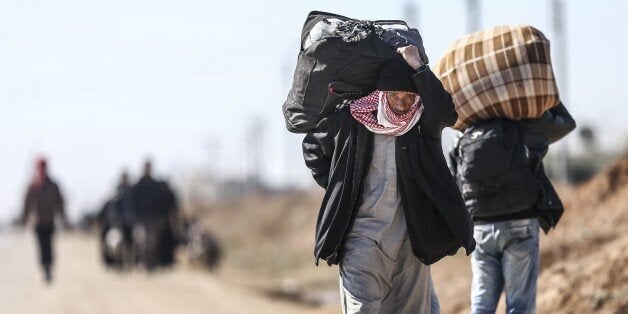 ALEPPO, SYRIA - FEBRUARY 09: Syrians who flee the attacks of Syrian and Russian air forces to residential areas on Hayan, Haritan, Kafr, Anadan, Kafr Naya, Mayir and Ihris districts of Syria, try to live at tents and open areas at the Bab al-Salameh border crossing on Turkish-Syrian border near Azaz town of Aleppo, Syria on February 09, 2016. (Photo by Fatih Aktas/Anadolu Agency/Getty Images)