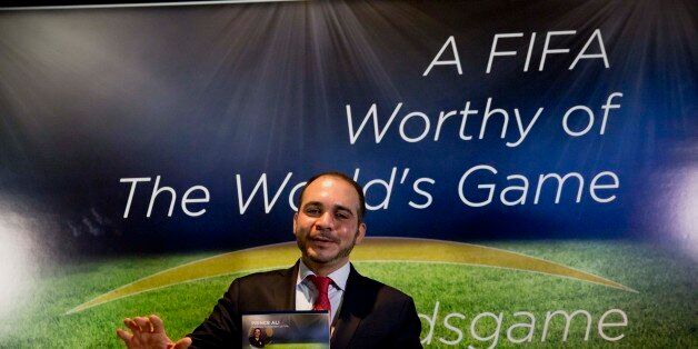 FIFA vice president Jordan's Prince Ali bin al-Hussein holds up a media pack as he poses for photographers at the end of a press conference for his FIFA presidency campaign launch in a London hotel, Tuesday, Feb. 3, 2015. Prince Ali bin al-Hussein says the United States was among the national associations to nominate him to stand against Sepp Blatter for the top job in world football. The Jordanian also disclosed he was endorsed by his home federation, Belarus, Malta, England and Georgia. (AP Photo/Matt Dunham)