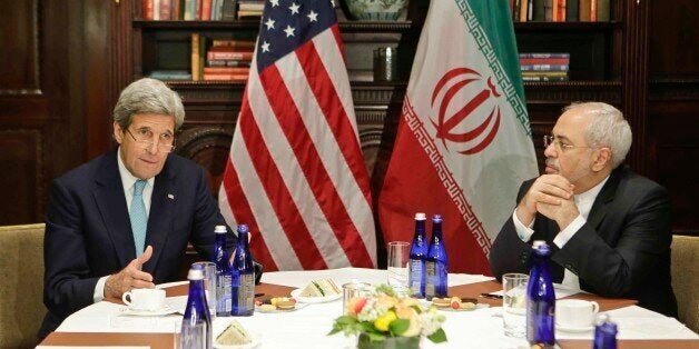 U.S. Secretary of State John Kerry, left, speaks to the media as Iranian Foreign Minister Mohammad Javad Zarif listens Friday, April 22, 2016, in New York. (AP Photo/Frank Franklin II)