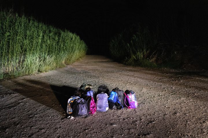 Backpacks lie in the road to be collected by U.S. Border Patrol agents after a group of Venezuelan immigrants was taken into custody. They had crossed the Rio Grande minutes earlier from Mexico to seek political asylum in the U.S.