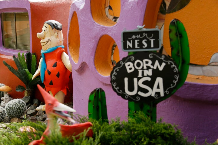 A statue of Fred Flintstone stands near the front entryway of the Flintstone House in Hillsborough, Calif. Technically, the owner of the fanciful Flintstones house in a posh San Francisco suburb settled a lawsuit with the town of Hillsborough. But the agreement will allow Fred and his friends to remain. (AP Photo/Eric Risberg, File)