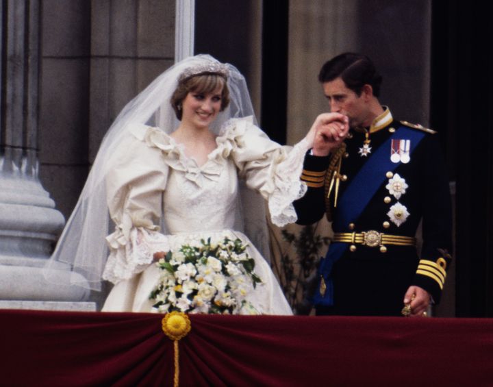 The Prince and Princess of Wales on the balcony of Buckingham Palace on their wedding day, July 19, 1981. Diana wears a wedding dress by David and Elizabeth Emmanuel and the Spencer family tiara.