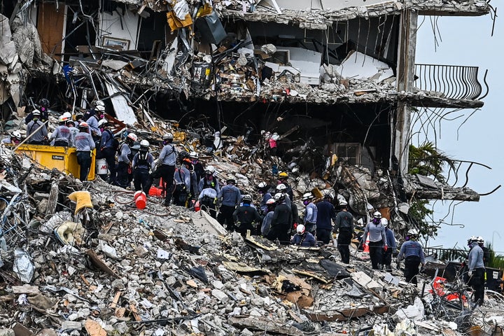 Search and Rescue teams look for possible survivors in the partially collapsed 12-story Champlain Towers South condo building
