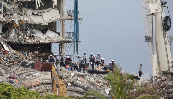 Searchers going through the ruins found the remains of six people Wednesday, bringing the number of confirmed dead to 18.