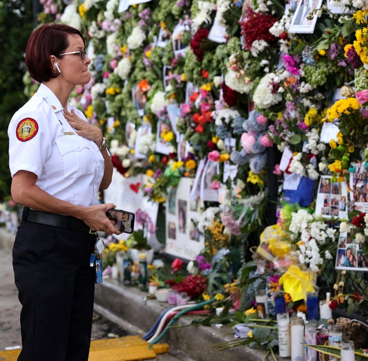 Miami-Dade Fire Rescue Chief Melanie C. Adams visits the makeshift memorial setup near the partially collapsed 12-story Champ