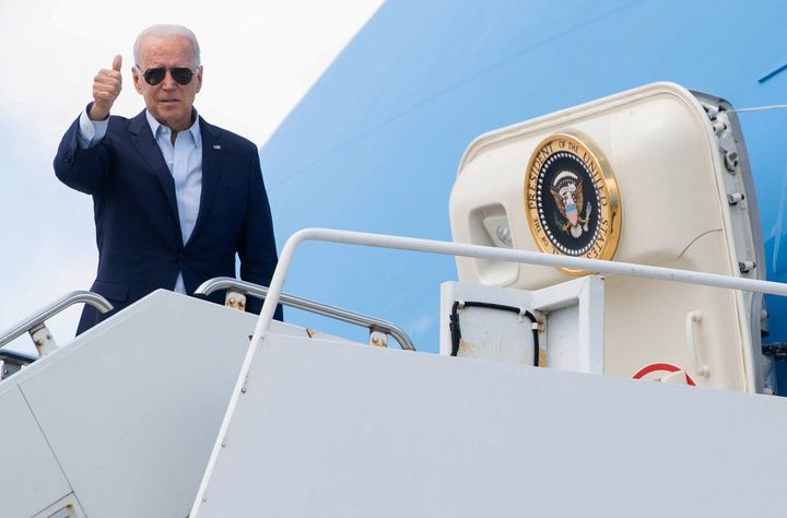 President Joe Biden gives a thumbs-up from Air Force One on Tuesday before departing La Crosse Regional Airport in La Crosse, Wisconsin, and traveling to promote his infrastructure plans.