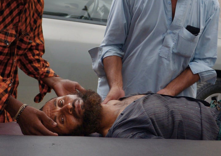 Pakistani relatives bring a heat stroke victim to a hospital in Karachi on June 25, 2015.