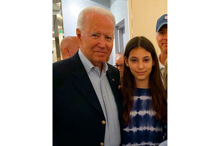 In this photo provided by a family member, 12-year-old Elisheva Cohen poses with President Joe Biden, Thursday, July 1, 2021, in Surfside, Fla., as the president and first lady visited the community devastated by the fatal collapse of the 12-story Champlain Towers South beachfront condominium a week earlier. (Contributed Photo via AP)