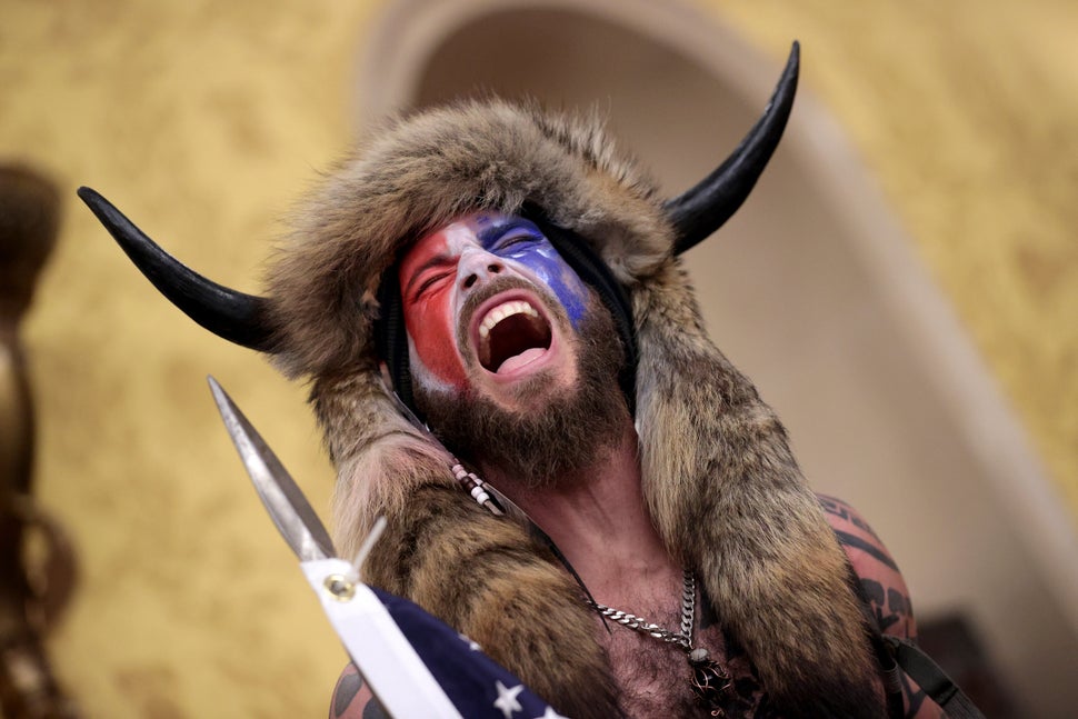 "QAnon Shaman" Jacob Chansley screams "Freedom!" inside the Senate chamber after the U.S. Capitol was breached by a mob durin