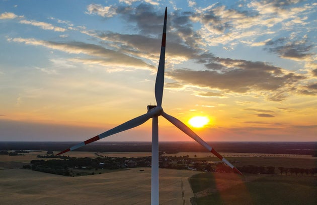28 June 2021, Brandenburg, Jacobsdorf: A wind turbine in the sunset in the Oder-Spree district in East...