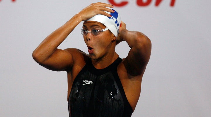 Coralie Balmy of France adjusts her cap before the start of women's 400m freestyle final at the European Swimming Championships in Eindhoven March 24, 2008. REUTERS/Damir Sagolj (NETHERLANDS)