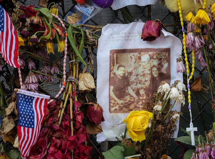 Flowers surround photos of the decease and missing before a burial service at St. Joseph Catholic Church in Miami Beach on Tu
