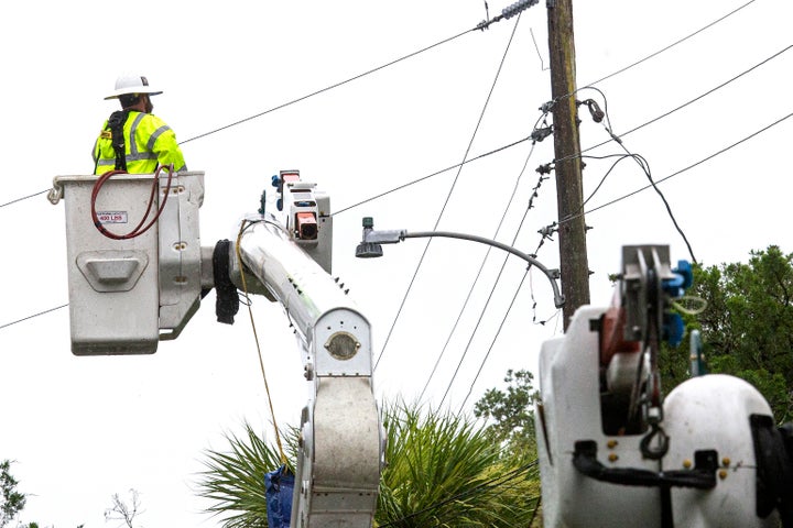 Power crews work to restore power after Tropical Storm Elsa made landfall on July 7, 2021 in Cedar Key, Florida.