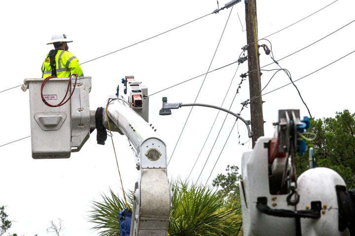 Power crews work to restore power after Tropical Storm Elsa made landfall on July 7, 2021 in Cedar Key, Florida. 