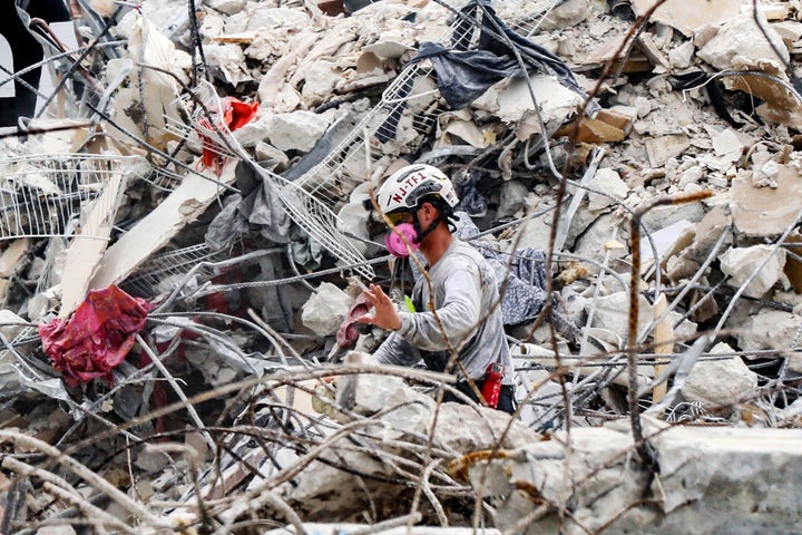 A search and rescue team member moves through the rubble on Wednesday.