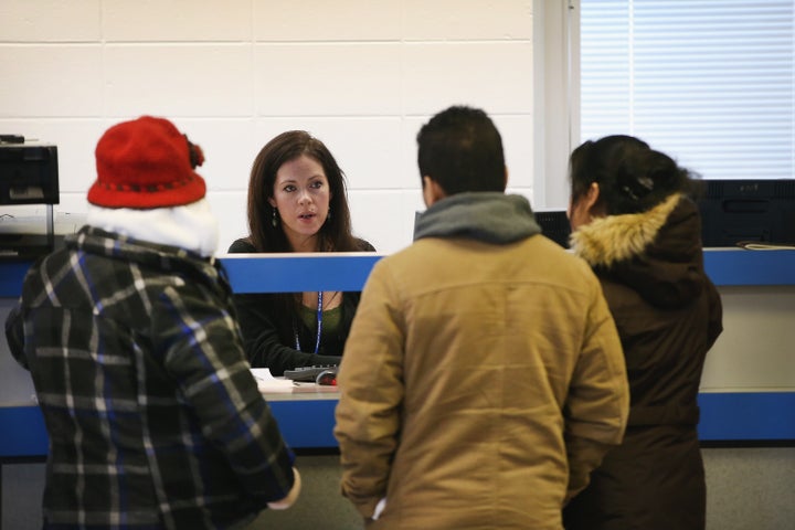 Residents apply for or renew their driver's licenses at a driver services facility on Dec. 10, 2013, in Chicago. Illinois' Temporary Visitors Driver's License program allows undocumented immigrants to obtain a driver's license. 