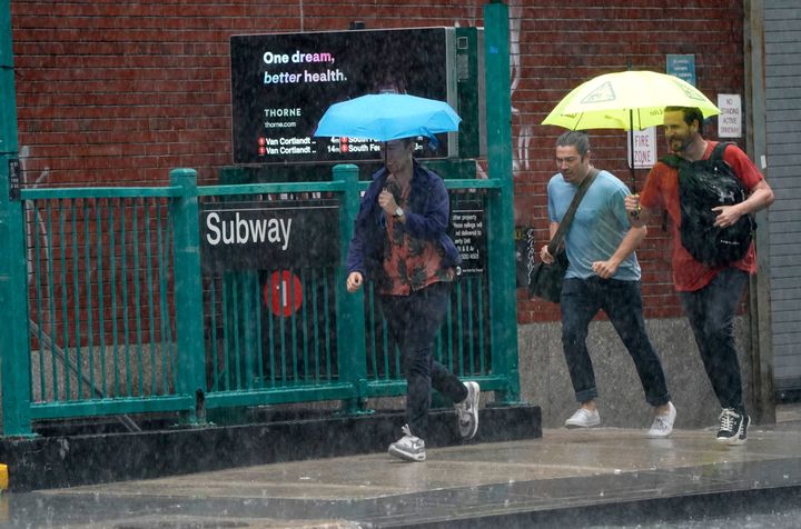 People run from the rain in the Chelsea area of New York.