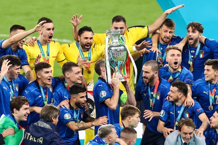 Italy's team lift the trophy after their victory on Sunday night