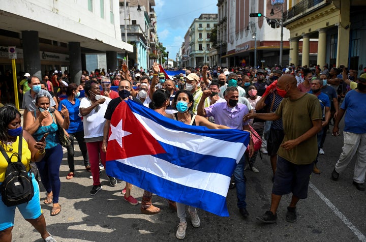 Thousands of Cubans took part in rare protests Sunday against the communist government, marching through a town chanting "Dow