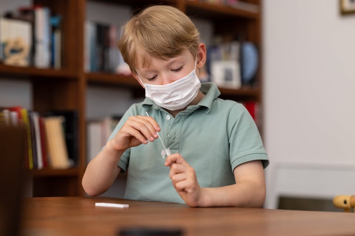 Young 6 year old school child carrying out a coronavirus self test